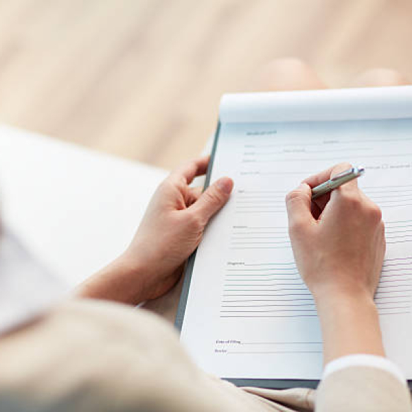 Female counselor writing down some information about her patient